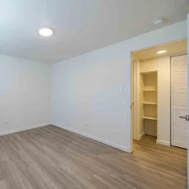 Unfurnished bedroom with wood-style flooring at Lime Apartments